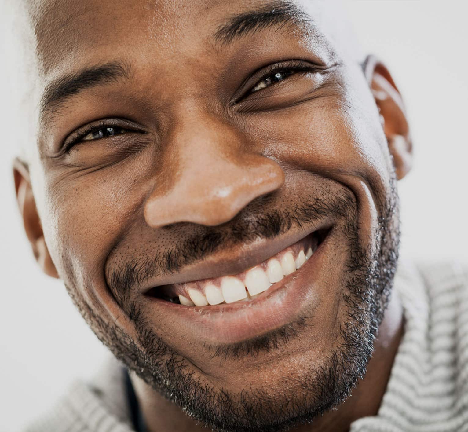 a close up of a man smiling for the camera